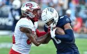 Malcolm Britt pushes off a Western Kentucky player to advance the ball for the Monarchs. Photo Chuck Thomas/ODU